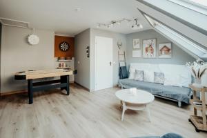 a living room with a couch and a table at 4 seasons house in Malmedy
