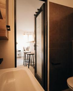 a bathroom with a bath tub and a table at Home lysea Major in Marseille +11 photos
