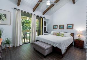 a bedroom with a bed and a large window at Turtle Bay Kuilima Collection 6 West in Kahuku