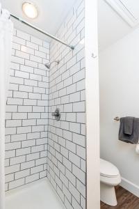a white tiled shower with a toilet in a bathroom at Turtle Bay Kuilima Collection 6 West in Kahuku +28 photos