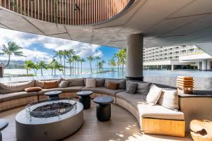 a living room with a couch and a pool at Turtle Bay Kuilima Collection 6 West in Kahuku
