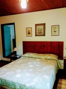 Cama ou camas em um quarto em Pousada Arboretum