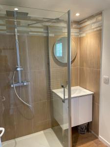 a shower with a glass door in a bathroom at Maison à la campagne in Auvilliers +12 photos