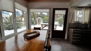 a kitchen with a wooden floor and large windows at ENDOR en VLA in Villa La Angostura