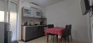 a kitchen with a table with a red table cloth at Fazana SS in Fažana
