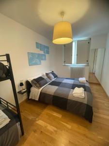 a bedroom with a large bed and a lamp at Appartamento Bacadama in Lecco