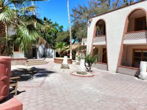 a courtyard of a house with palm trees at Sandy Shores Cabaña 8A in La Paz +19 photos