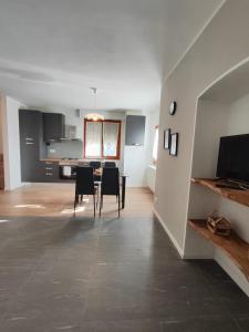 a kitchen and dining room with a table and chairs at Fiada Holiday Home in Albosaggia