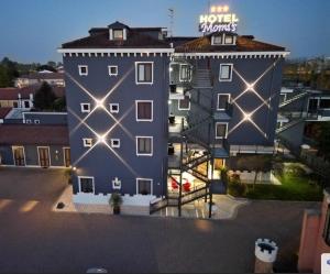 a building with a sign on the side of it at Momi's Hotel in Cavarzere