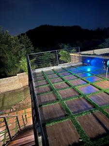 a set of steps leading up to a pool at night at Genk Farmhouse in Kwatiakwa