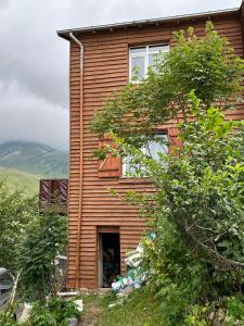 a wooden house with a window on the side of it at DORUK Pansiyon in Çaykara +20 photos