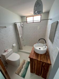 a bathroom with a sink and a toilet and a shower at Coco farm stay Suanphueng in Ratchaburi