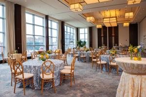 a banquet hall with tables and chairs in a room with windows at InterContinental Boston by IHG in Boston +37 photos