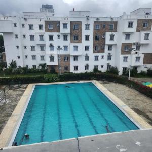 an empty swimming pool in front of a building at ANM Buxton Point Apartment in Mombasa