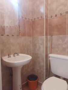 a bathroom with a sink and a toilet at departamento céntrico frente a plaza libertad in Santiago del Estero +4 photos