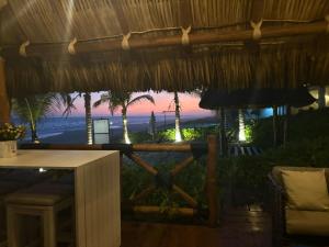 a view of the beach from a restaurant with a view of the ocean at Villa Marena Hotel Boutique in Coyuca