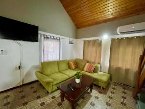 a living room with a green couch and a table at La Cico 1 in Dubova