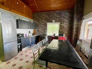 a kitchen with a table and chairs in a room at La Cico 1 in Dubova