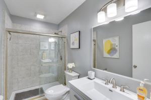 a bathroom with a shower and a toilet and a sink at 3 Mi to the Lake Rocky Mount Home with Water Views! in Rocky Mount +16 photos