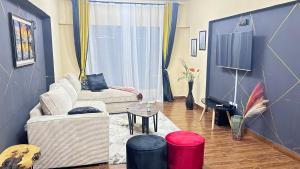 a living room with a couch and a table at Crystal Sky 2-Bedrooms with 3 beds Pool and balcony in Nairobi