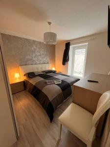 a bedroom with a bed and a desk and a chair at Abete Bianco in Mezzano