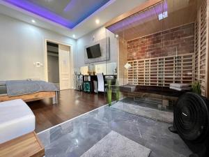 a living room with a brick fireplace and a bed at JohnGold Wellness Room in Debrecen
