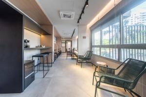 ein leeres Wartezimmer mit Stühlen und Fenstern in der Unterkunft "1103 - Studio Moderno e Completo no Campo Belo!" in São Paulo