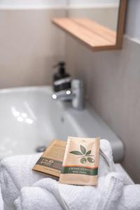 a book sitting on top of a towel on a sink at ES Apartments in Nago-Torbole