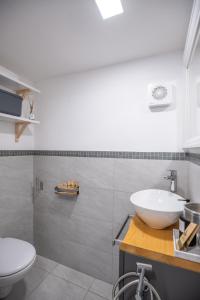 a bathroom with a sink and a toilet at ES Apartments in Nago-Torbole +94 photos