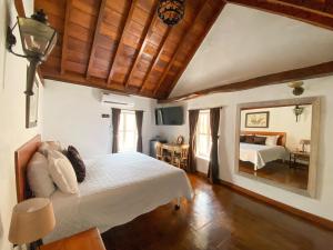 a bedroom with a bed and a large mirror at Life is Good Cartagena Hostel in Cartagena de Indias
