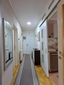 a hallway of a room with a sink and a kitchen at Beautiful house in Smederevo +14 photos