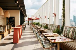 a row of tables and chairs on a rooftop restaurant at The Hoxton, Brussels in Brussels