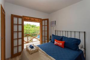 Ένα ή περισσότερα κρεβάτια σε δωμάτιο στο Casa com Área Gourmet e Piscina em Búzios | Céu 27 +53 φωτογραφίες