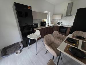 a kitchen with a couch and chairs and a table at Apartament PREMIUM z ruską banią, kominkiem i oranżerią w centrum in Brodnica