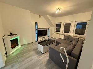 a living room with a couch and a tv at Guestroom K17 in Thale
