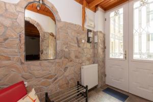 a room with a stone wall and a door at Buda or Pest in Budapest