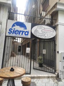 a gate with a sign on the side of a building at Acropolis Rooftop Monastiraki Centrral Gem in Athens