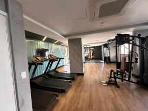 a gym with several tread machines in a room at Liberdade Loft & Comfort in São Paulo