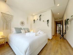 a white bedroom with a large white bed at Boho 2BR Cozy App Jacuzzi & Pool in Rabat +21 photos