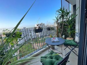 a balcony with a table and a view of the city at Boho 2BR Cozy App Jacuzzi & Pool in Rabat