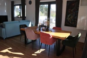 a dining room with a wooden table and chairs at Ferienwohnung Nalbach Wohnung 1 in Nalbach