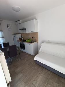 a small room with a bed and a kitchen at Lana2 in Starigrad-Paklenica