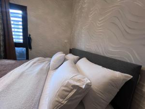 a bedroom with a bed with white pillows at Luxury Living - privado, Madinaty in Madinaty