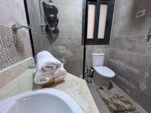 a bathroom with a sink and a toilet at Luxury Living - privado, Madinaty in Madinaty +7 photos