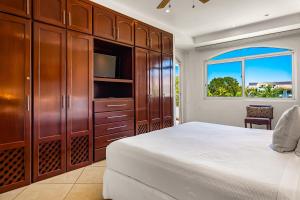 a bedroom with a bed and a tv and a window at Greenbay Depto 303 in Nuevo Vallarta  +46 photos