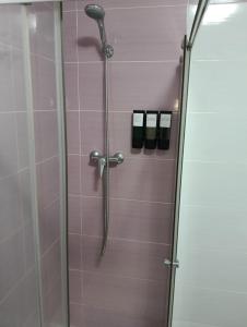 a shower in a bathroom with a glass door at Casa Paco in Linares