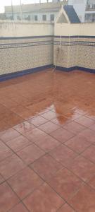 a tiled floor with a pool of water on a building at Casa Paco in Linares +5 photos