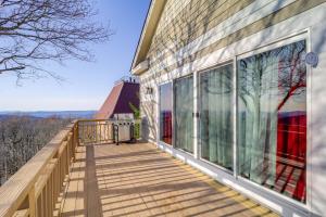 a balcony of a house with large windows at 3 Mi Beech Mtn Resort: Cozy Studio w/ Deck & View! in Beech Mountain