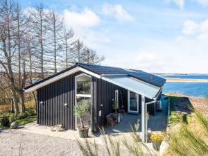 a black tiny house with a solar roof at 5 star holiday home in Løgstrup in Løgstrup
