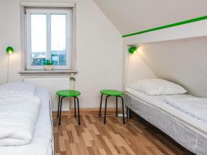 a bedroom with two beds and two green stools at Seaside Retreat in Thyboron-By Traum in Thyborøn +26 photos